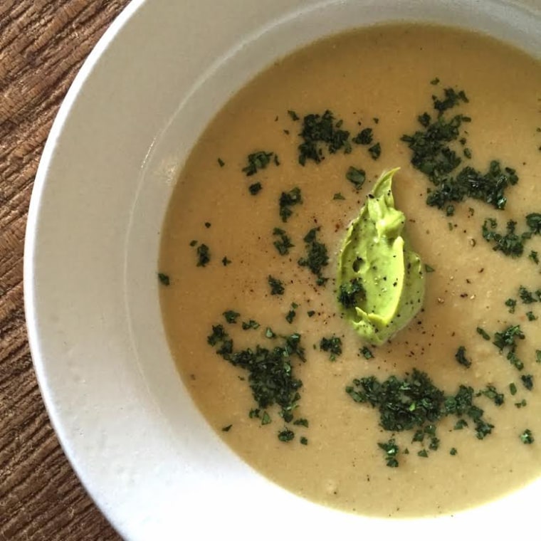 Creamed summer corn soup with chopped cilantro and avocado puree.