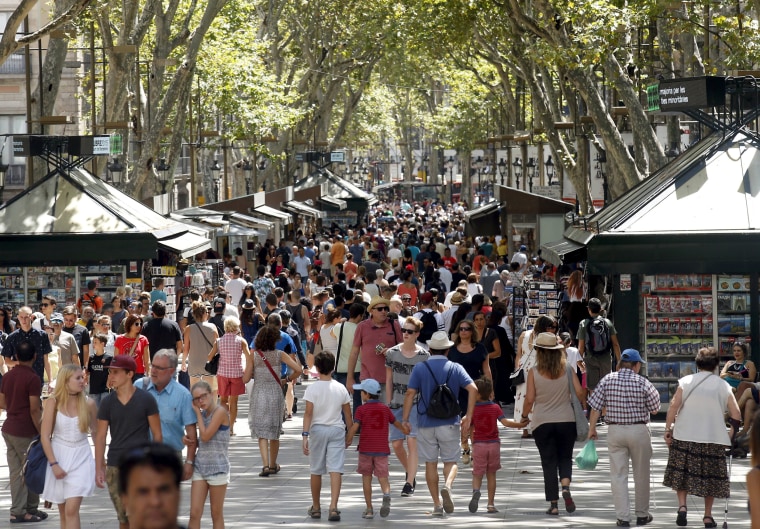 Image: FILE PHOTO: People walk by Las Ramblas in Barcelona