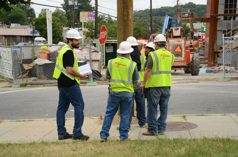 John Monroe with the Foundation for Fair Contracting talks to workers on a federally funded construction job. Monroe says he's never been to a job site where he didn't encounter a case of wage theft.