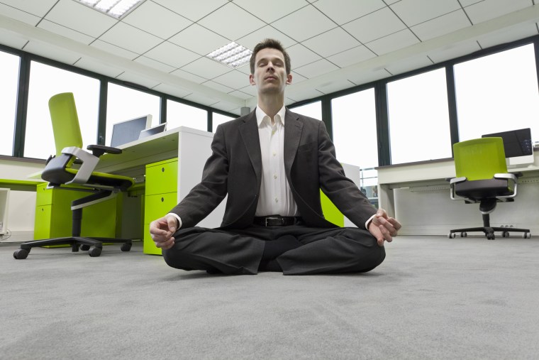 businessman practicing meditation in office