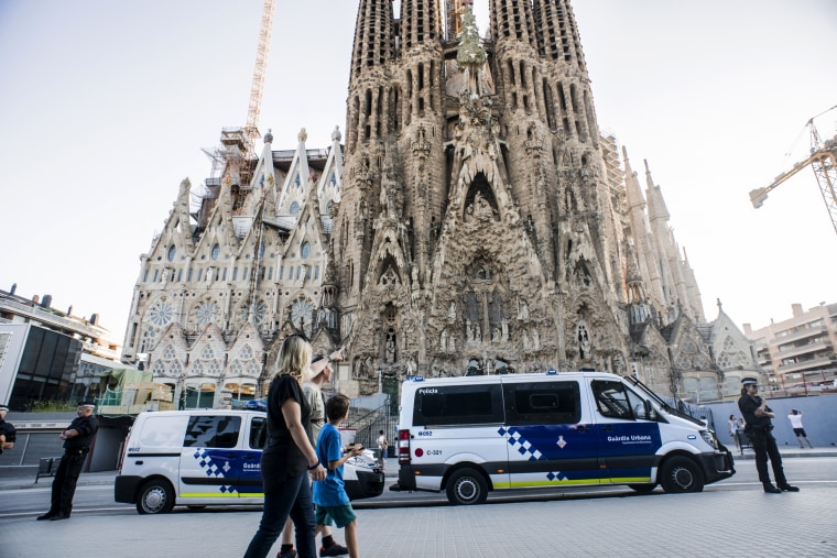 Image: Guards watch over La Sagrada Familia in Barcelona.