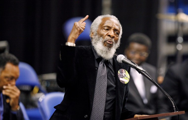Image: Dick Gregory speaks at the 2011 funeral for singer James Brown.