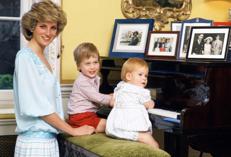 Princess Diana is pictured with her sons, Prince William and Prince Harry, at the piano in Kensington Palace.