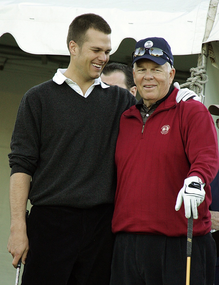 New England Patriots football quarterback Tom Brady, left, hugs his father Tom Brady Sr. on the first hole of the Poppy Hills course in Pebble Beach, California.