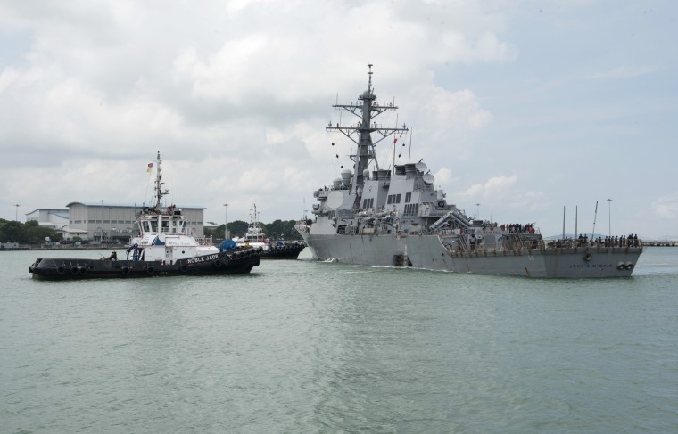 Image: Tugboats from Singapore assist the guided-missile destroyer USS John S. McCain as it steers towards Changi Naval Base, Singapore