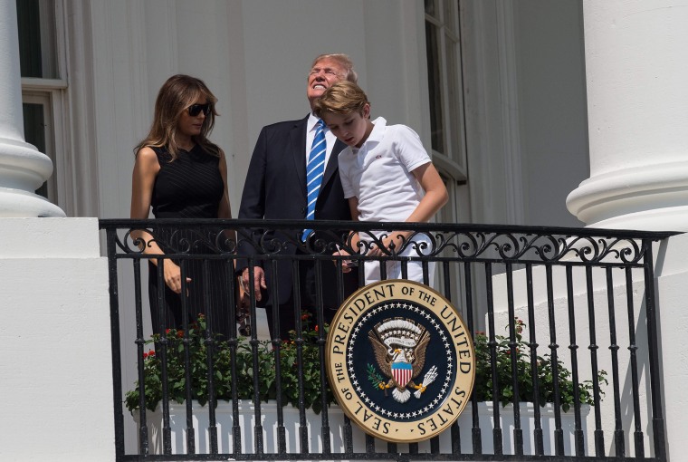 Image: President Donald Trump, First Lady Melania Trump and son Barron look up at the partial solar eclipse from the balcony of the White House in Washington, DC, on Aug. 21, 2017.