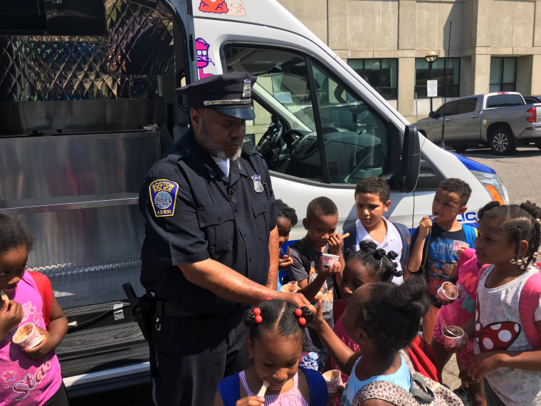 Officer Kenneth Grubbs talks to Boston children after handing out ice cream.