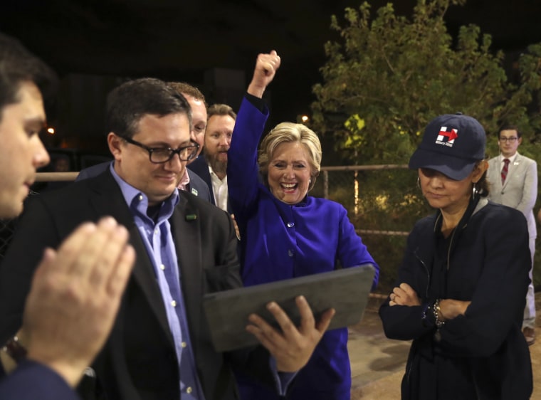 Image:  Clinton watches the World Series baseball game between the Chicago Cub and the Cleveland Indians