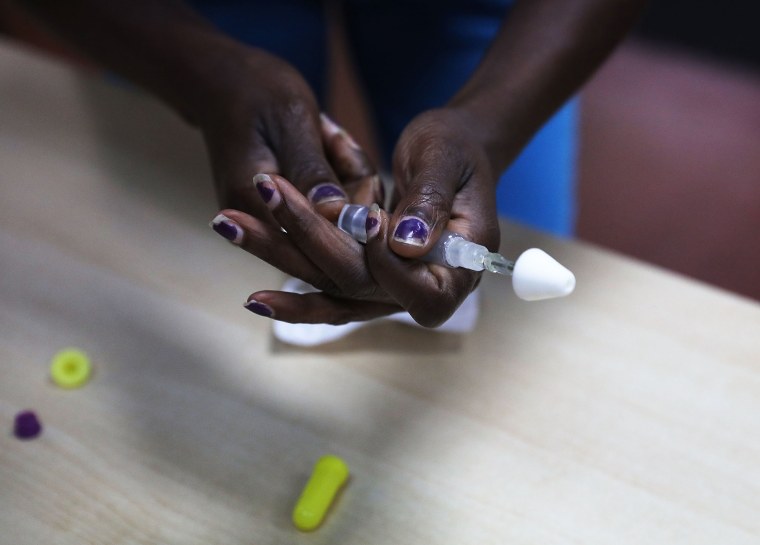 Image: Students learn to put together a Naloxone spray gun in a class on opioid overdose prevention