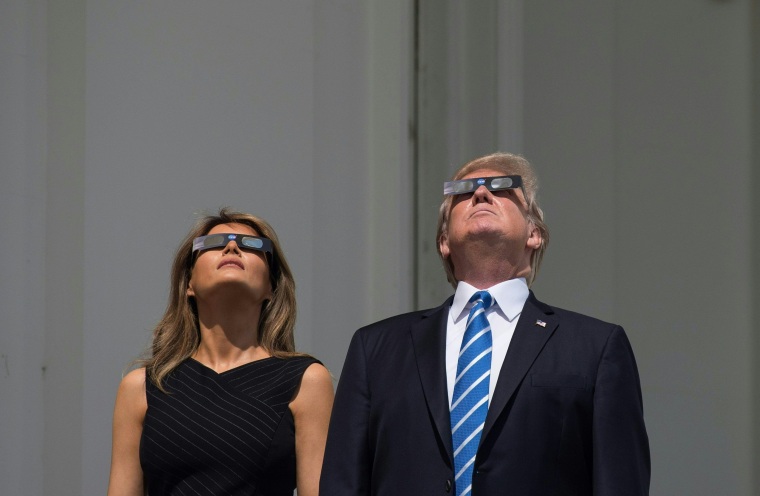 Image: Trump and and Melania look up at the solar eclipse from the balcony of the White House