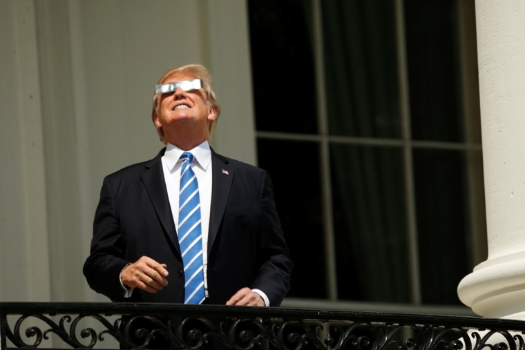 Image: Trump watches the solar eclipse from the Truman Balcony at the White House in Washington