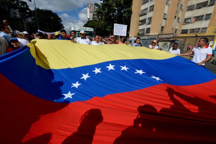 Health care workers holding Venezuela's national flag demonstrate against President Nicolas Maduro's government, in Caracas on February 7, 2017.