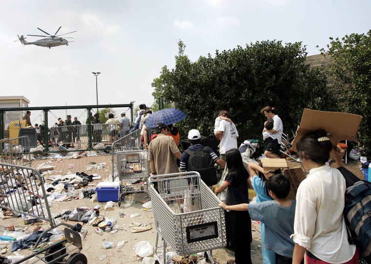 Image: Evacuees wait to be evacuated by helicopter from the Convention Center in New Orleans after Hurricane Katrina