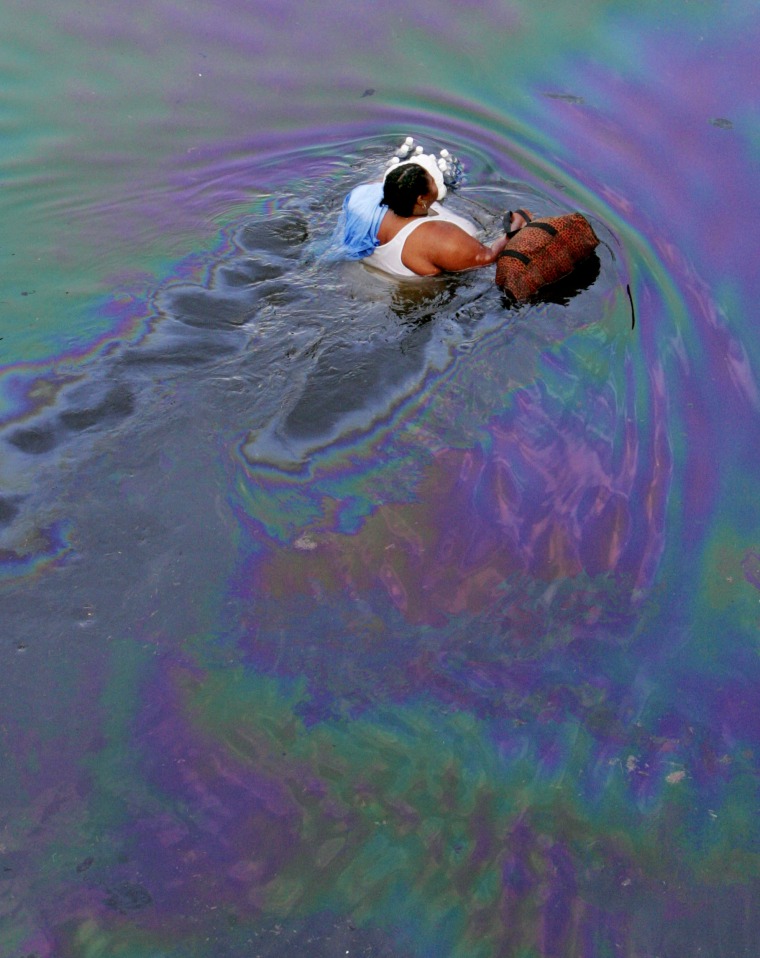 Image: A New Orleans resident walks through floodwaters