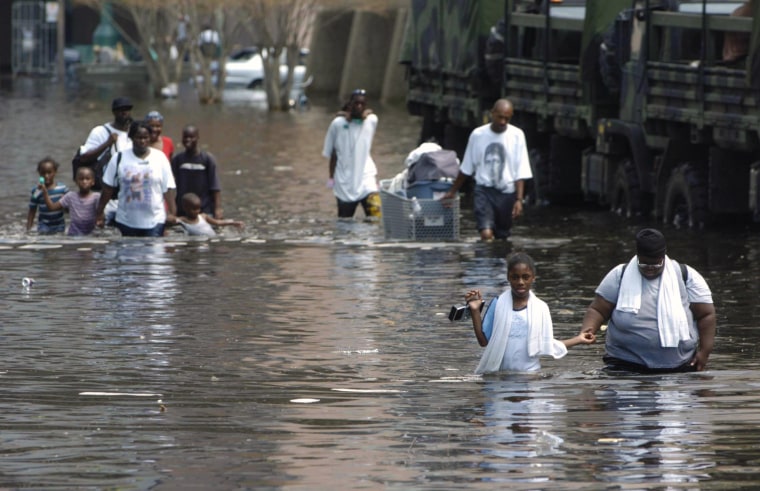 Image: People wade through floodwaters on their way to the Superdome in New Orleans looking for shelter