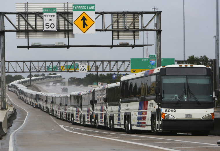 Image: Empty city buses line up on Interstate 59 near Houston Saturday in case their bus shelters flood from Hurricane Harvey