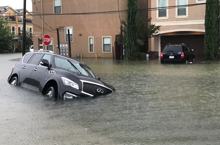 Image: A vehicle sits half submerged in flood waters in a residential area in the aftermath of Hurricane Harvey in Houston