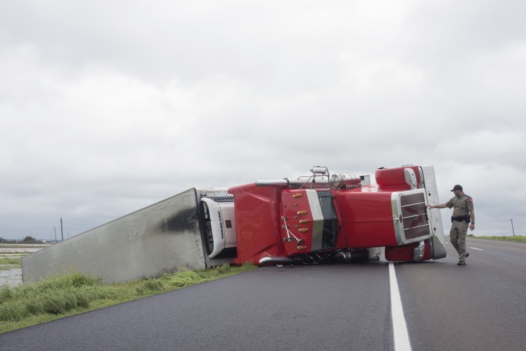 Image: Police respond to a truck overturned during Hurricane Harvey in El Toro, Texas