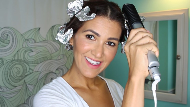 Clamp flat iron down on foil to steam hair into bouncy curls.