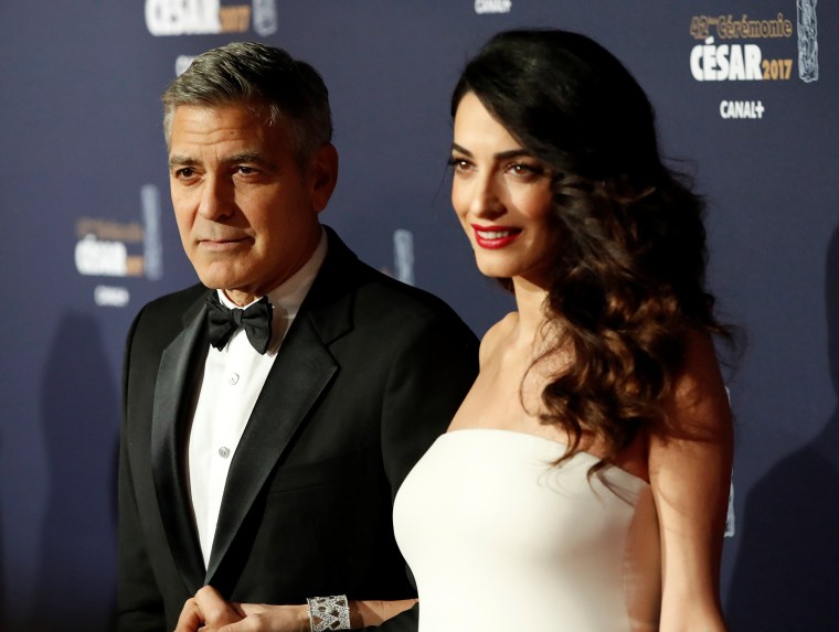 Image: FILE PHOTO: Clooney and his wife Amal pose as they arrive at the 42nd Cesar Awards ceremony in Paris