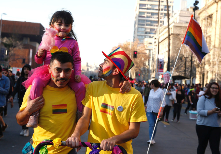 Image: FILE PHOTO: A couple take part in the gay pride to demand a new law of gender equality after President Michelle Bachelet sets marriage equality as government priority,  Santiago