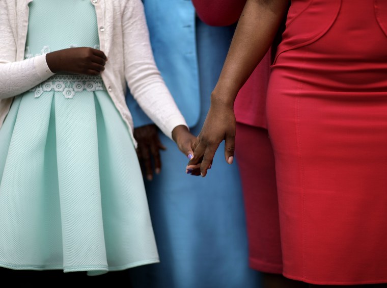 Image: Yolanda King, 9, left, the granddaughter of the Rev. Martin Luther King Jr., holds the hand of her mother Arndrea Waters King