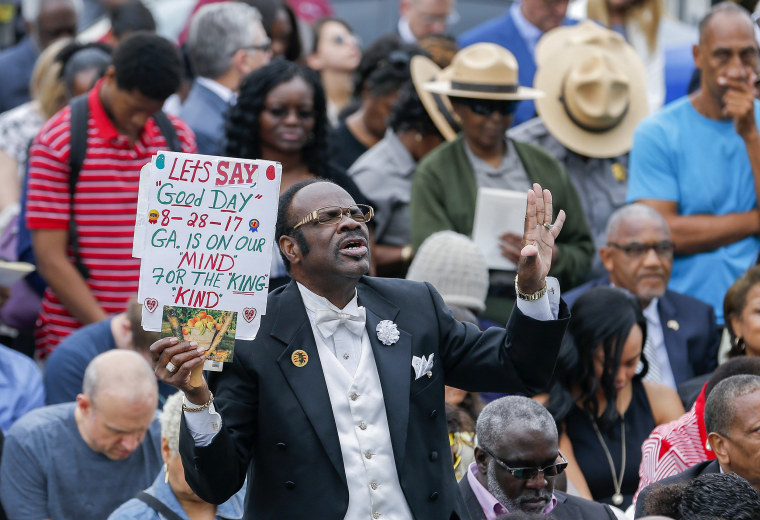 Image: A man reacts during the unveiling ceremony of a statue of slain civil rights leader Martin Luther King Jr.