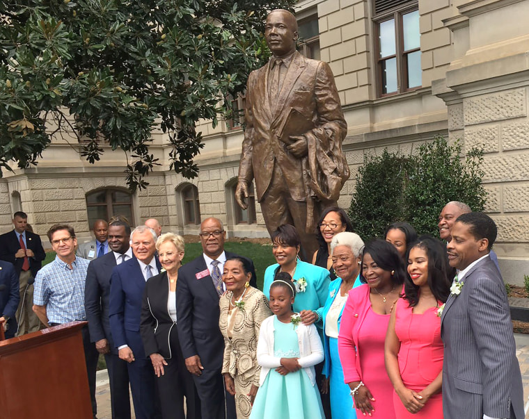 Image: Members of Martin Luther King Jr.'s family and Georgia elected leaders stand in front of the Martin Luther King Jr. statue unveiled in Atlanta