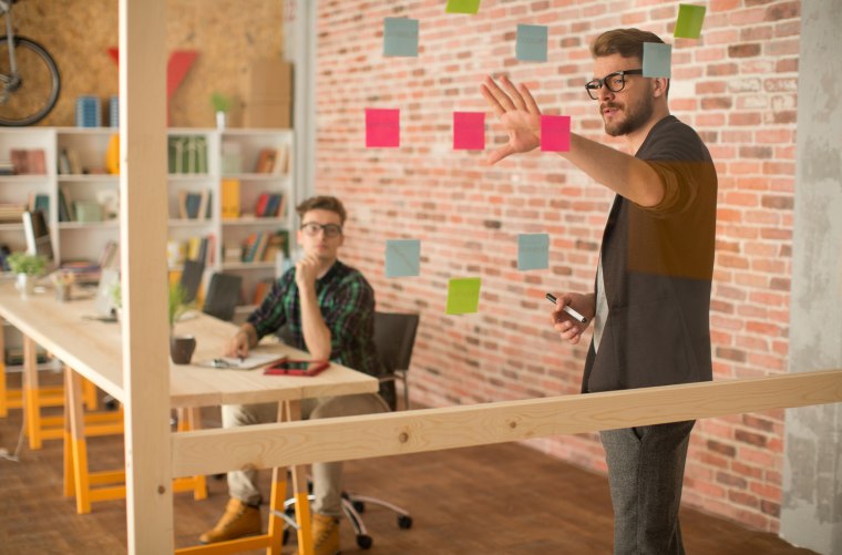 Image: Two men work in an office