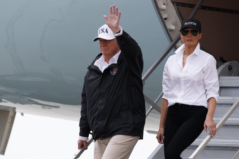 Image: President Donald Trump, accompanied by first lady Melania Trump, waves as they arrive on Air Force One at Corpus Christi International Airport