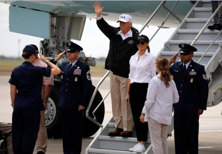 Image: President Donald Trump, accompanies by first lady Melania Trump, waves upon arrival in Corpus Christi, Texas