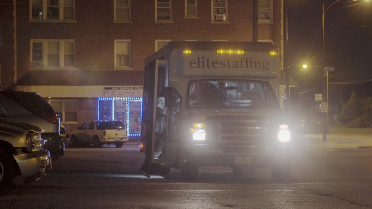 Image: White vans pick up temporary workers outside an office in Chicago