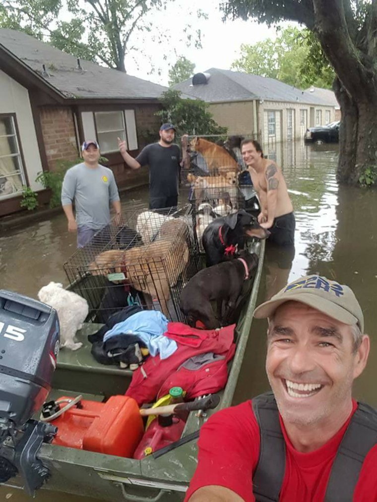 Image: Good Samaritans Buck Beasley, Jeremy Williams and Anthony Hernandez helped animal rescuer Betty Walter transport her dogs to safety in southeast Houston, Texas on August 30, 2017.