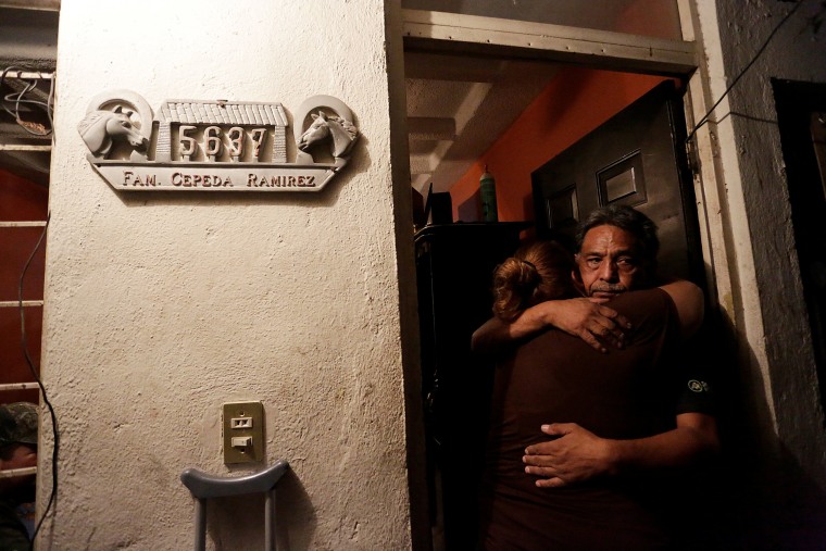 Image: Relatives of the Saldivar family, whose van was reportedly carrying six family members when it was swept away by floodwaters from Hurricane Harvey, comfort each other at their house in Monterrey