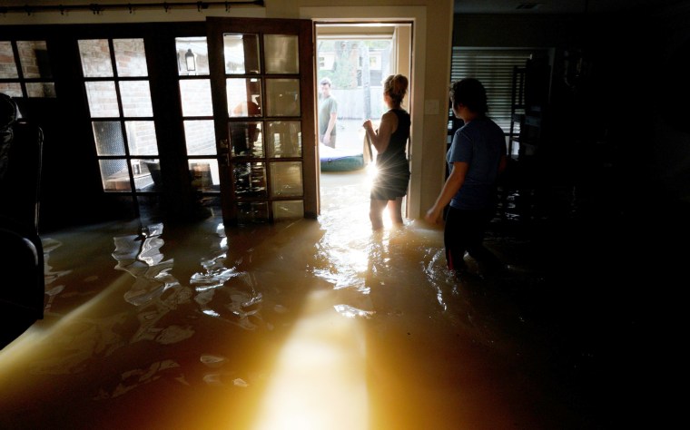 Image: A family that wants to remain anonymous moves belongings from their home flooded by Harvey in Houston, Texas, Aug. 31, 2017.