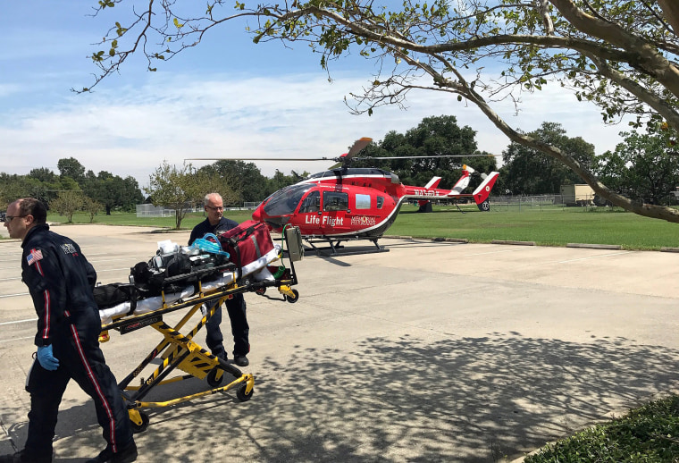 Image: Life Flight, a critical care air medical transport service is seen assisting evacuation due to lack of running water at the Baptist Beaumont Hospital, in southeast Texas