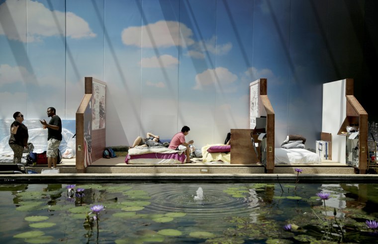 Image: Families displaced by flooding from flooding by Hurricane Harvey shelter at Gallery Furniture