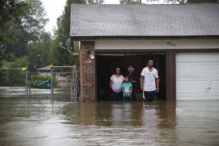 Image: People wait to be rescued from their flooded homes after their neighborhood was inundated with rain