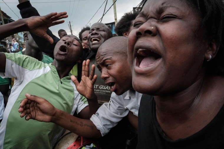 Image: Supporters of Kenya's opposition party joke as they pretend to cry for Kenyan President Uhuru Kenyatta
