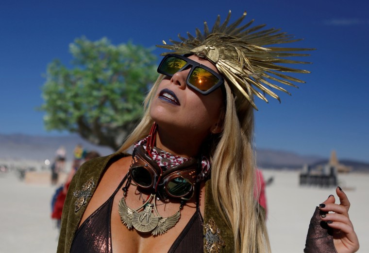 Image: Pili Montilla wears a headdress as approximately 70,000 people from all over the world gathered for the annual Burning Man arts and music festival in the Black Rock Desert of Nevada