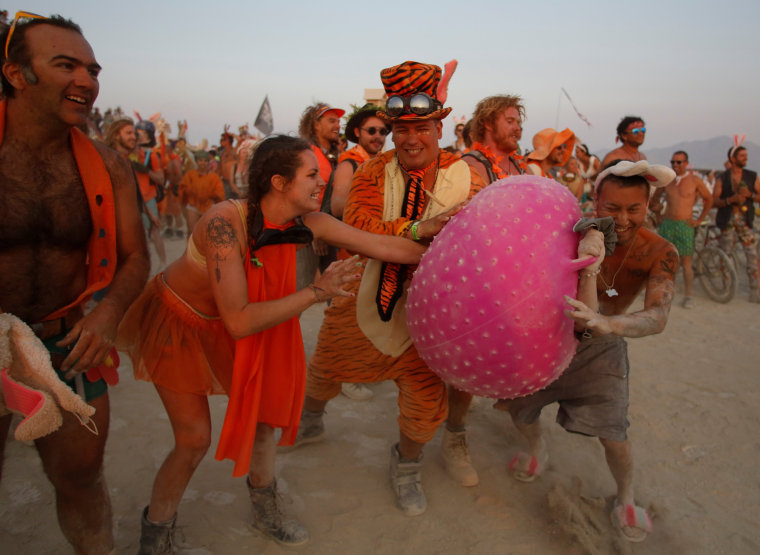 Image: Members of the carrot team try to prevent members of the Bunny March from reaching the Man as approximately 70,000 people from all over the world gathered for the annual Burning Man arts and music festival in the Black Rock Desert of Nevada