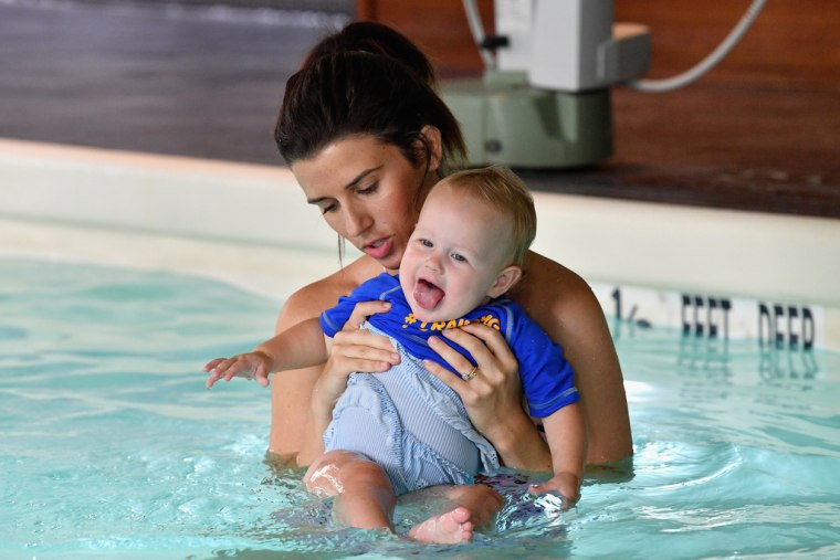 Here's how I would normally hold my baby in the pool. While she may be smiling, notice how most of her body is out of the water? 