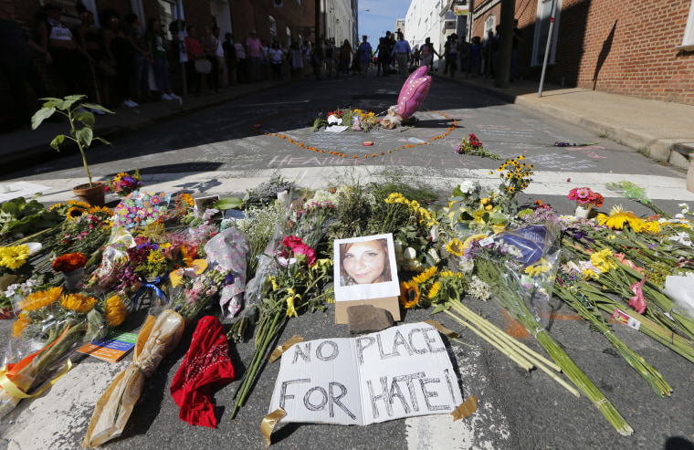Image: A makeshift memorial of flowers and a photo of victim Heather Heyer