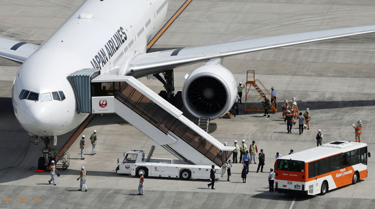 Image: A Japan Airlines plane bound for New York that returned to Tokyo's Haneda airport for an emergency landing due to engine trouble, is seen in Tokyo