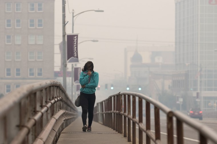 Image: Tatiana Weed walks to work through smoke in Missoula