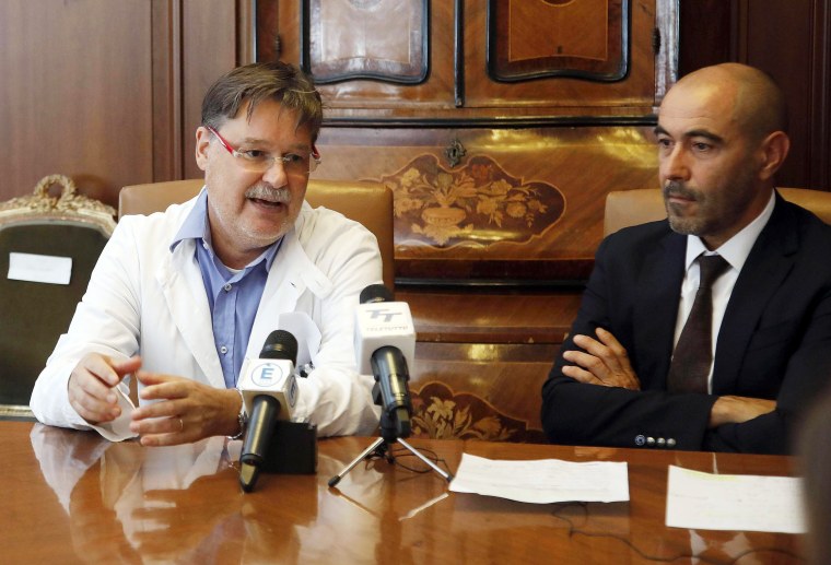 Image: Tropical diseases expert Alberto Matteelli, left, is flanked by Ezio Belleri, general manager of the "Spedali Civili" hospital
