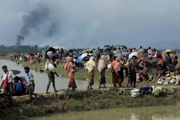 Image: Smoke billows above what is believed to be a burning village in Myanmar's Rakhine state as members of the Rohingya Muslim minority take shelter