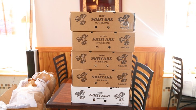 Boxes of shiitake mushrooms purchased through a WeChat buying group in East Asian Fusion restaurant in New Jersey.