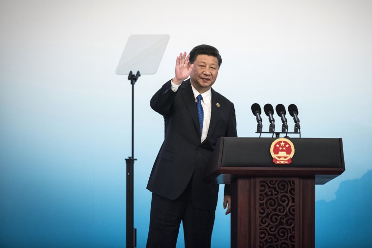 Image: China's President Xi Jinping waves during a press conference