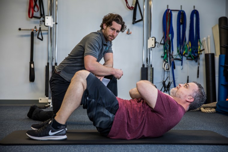 Daniel L. Green being evaluated by his personal trainer